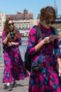 Two asian women tourists dressing the same way walking at Dumbo waterfront.